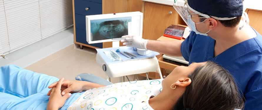 Dentist Accept Delta Dental, Muskegon dentist showing dental X-ray to patient with Delta Dental coverage